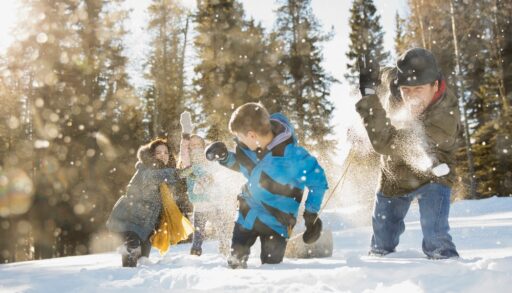 Family having snowball fight outdoors