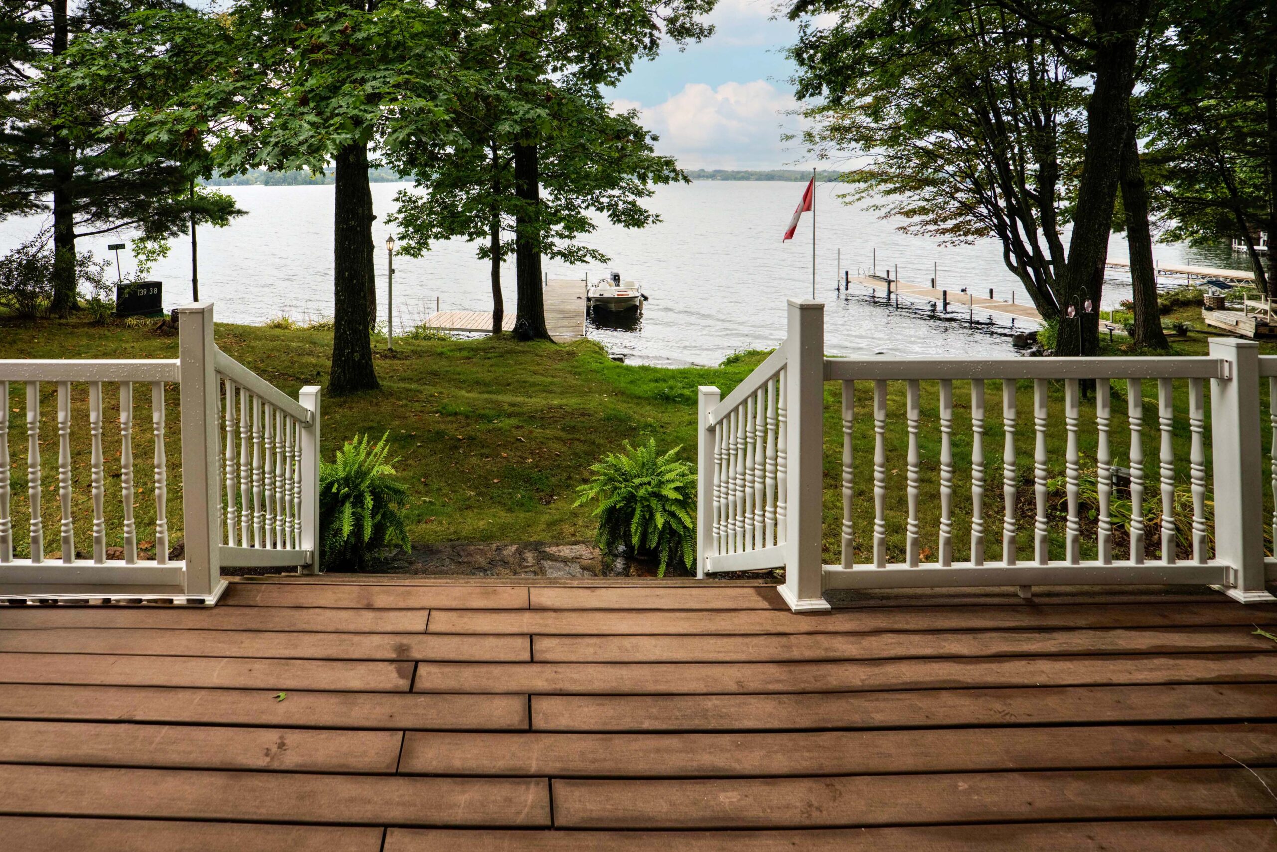 A grey couch faces a stone fireplace in a wood living room
