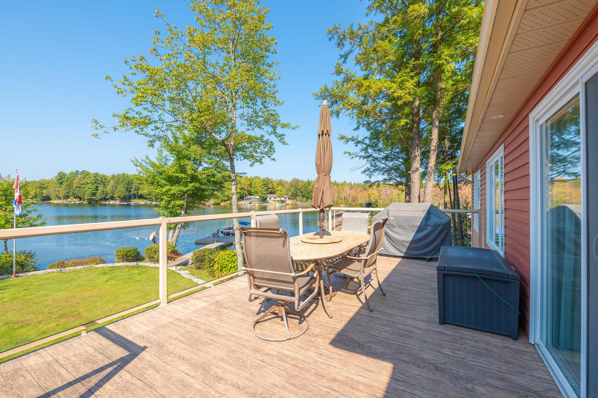 A spacious outdoor patio area with seating, offering stunning lake views.