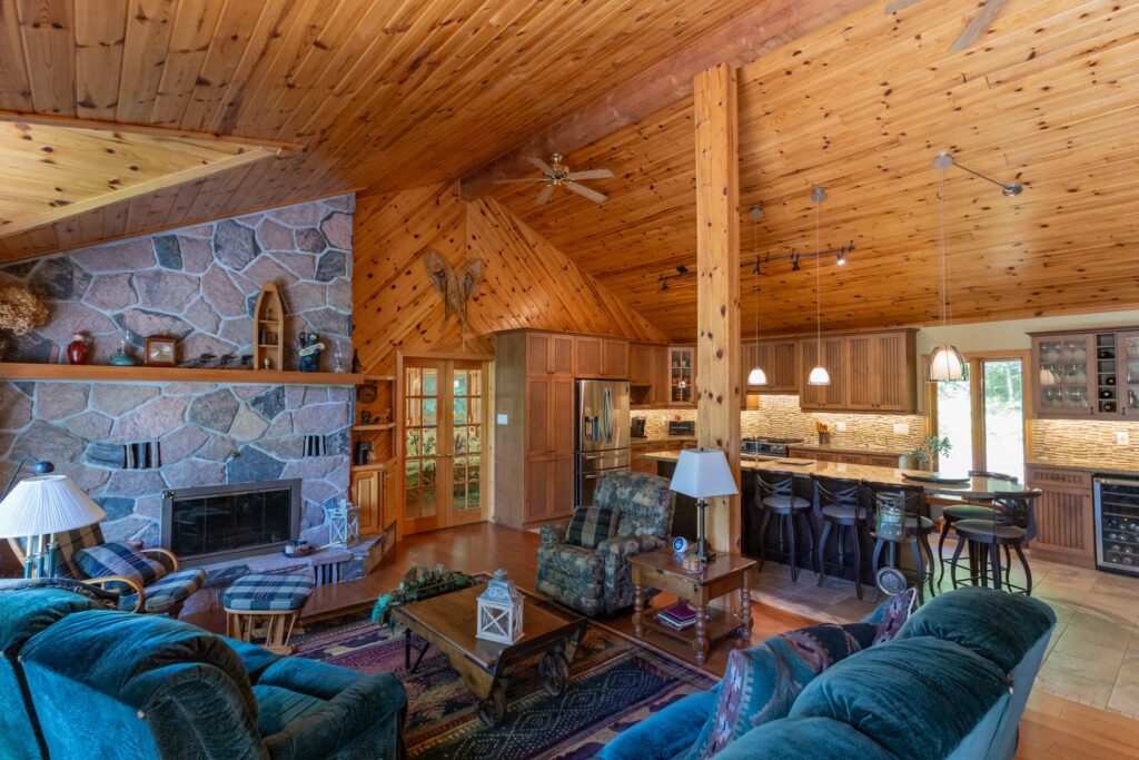 A wood room with couches facing in each other. To the right, a wood kitchen