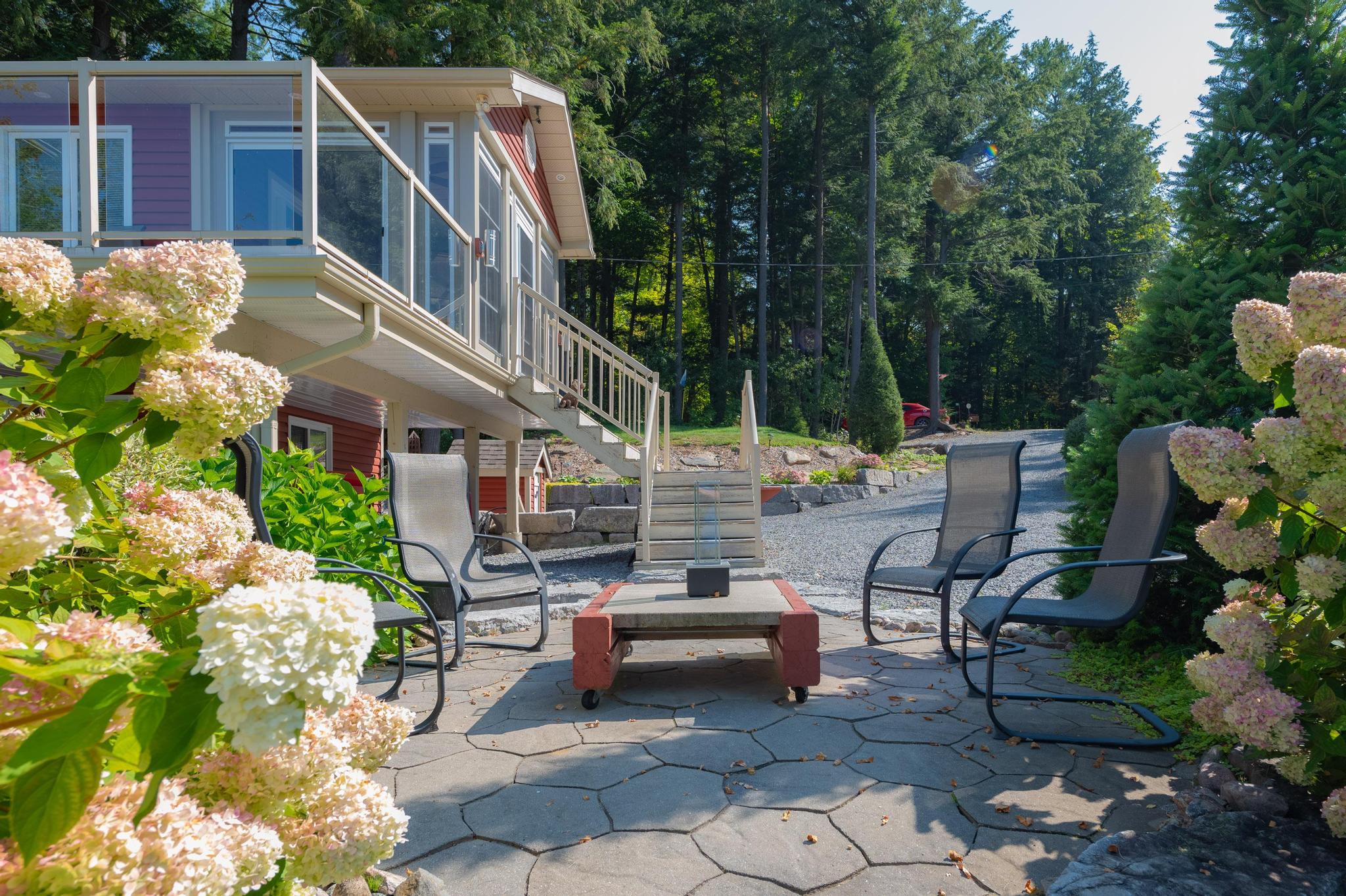 A multi-level wooden deck with an outdoor staircase leading to different parts of the property.