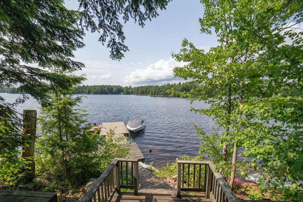 Scenic view of Kahshe Lake from a wooden deck surrounded by trees