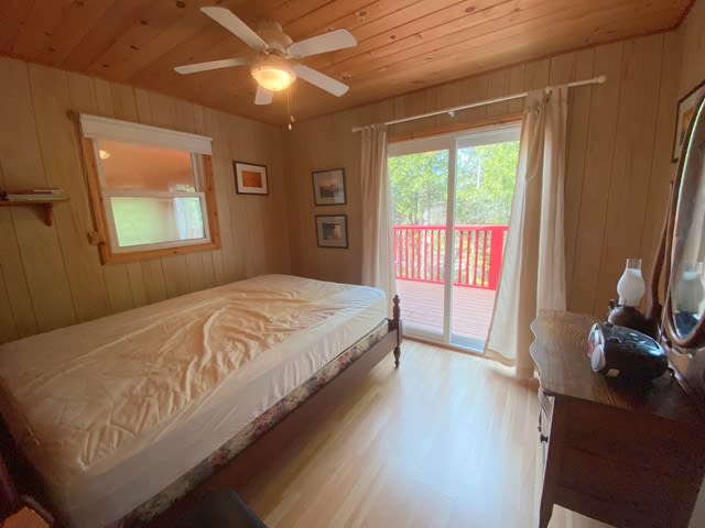 A white twin bed in a beige room