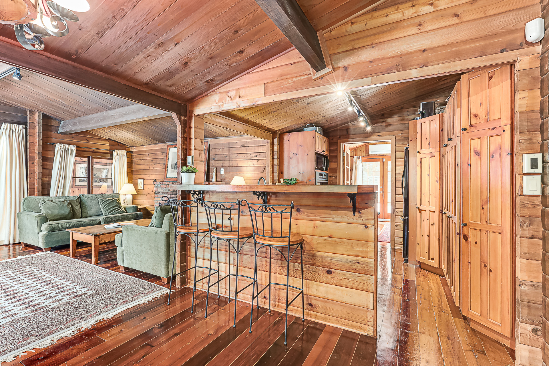A wood high-top kitchen island with metal chairs