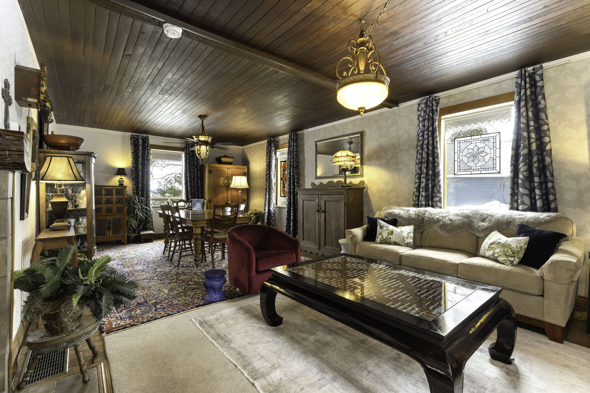 Warm and inviting living room with wood ceilings and fireplace