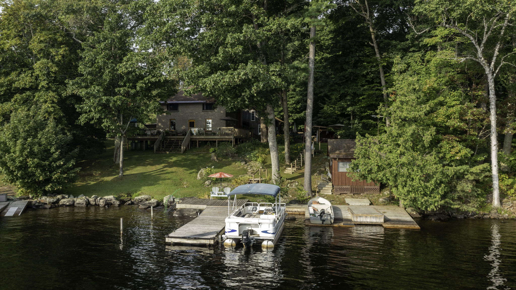 Shoreline view with crib docks and seating area at Lake Muskoka