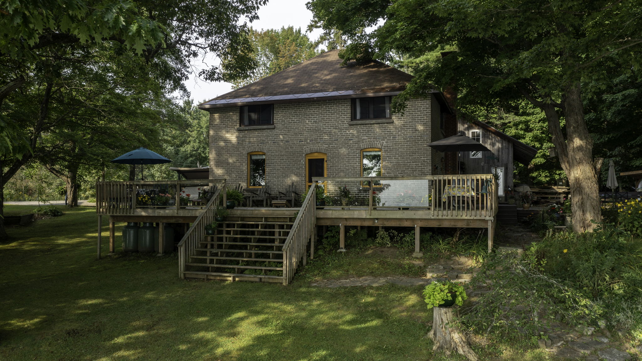 Side view showing landscaped grounds and charming farmhouse design