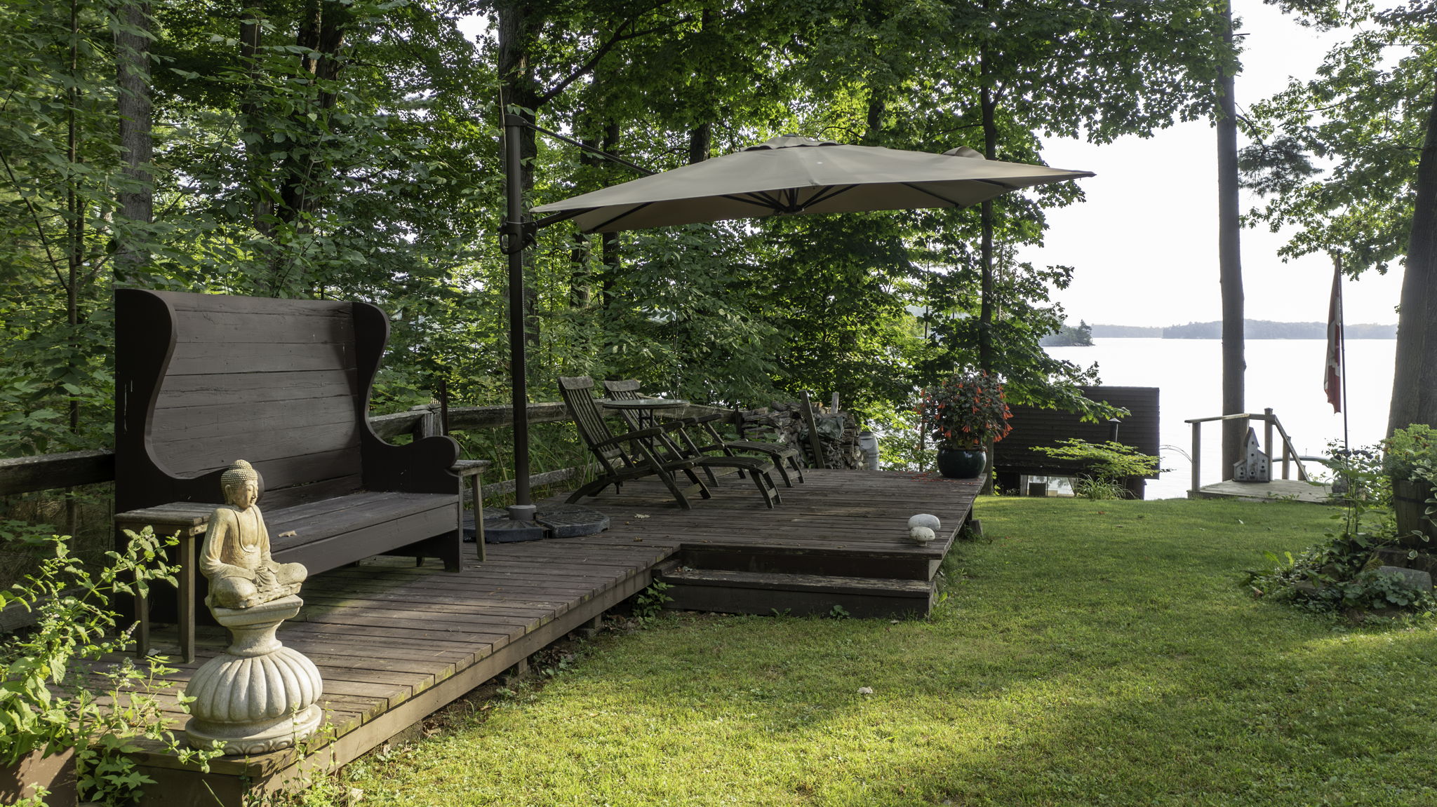 Shaded sitting area overlooking Lake Muskoka's shoreline