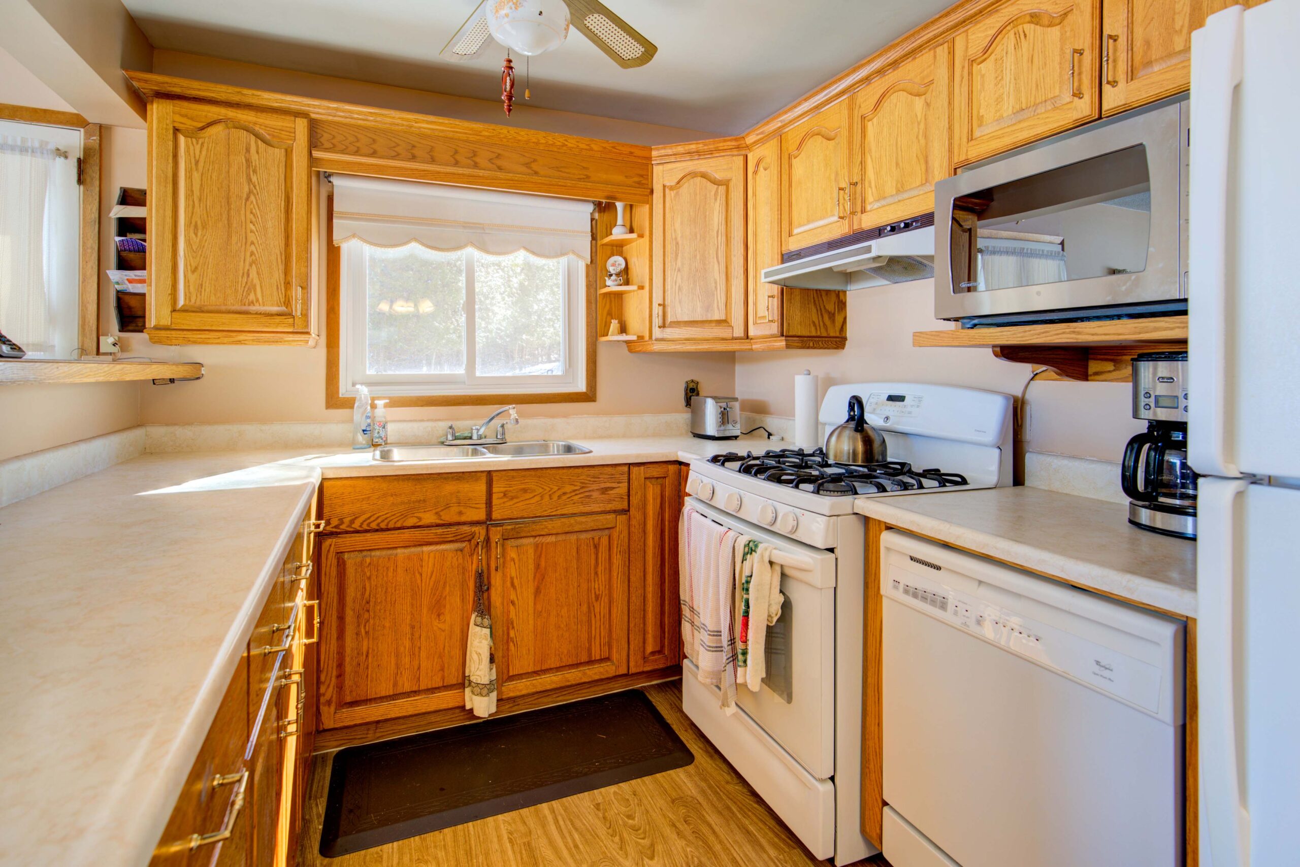 A wood kitchen with white appliances