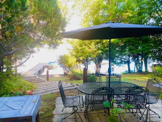 A black metal patio set next to a lake