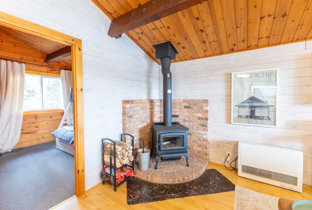 A wood stove in a brick corner