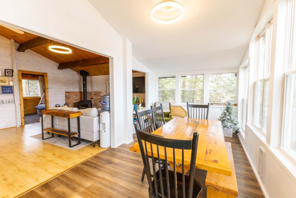 A wood dining table with dark brown chairs in a white room