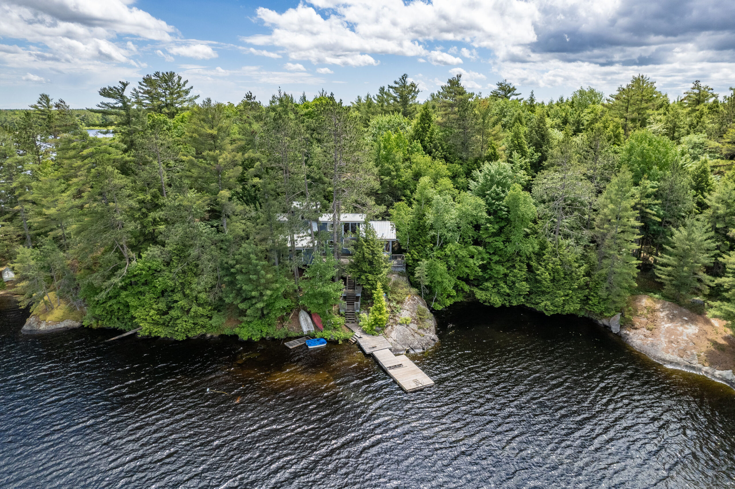Overhead view of the cottage and dock nestled in a private bay on Kahshe Lake