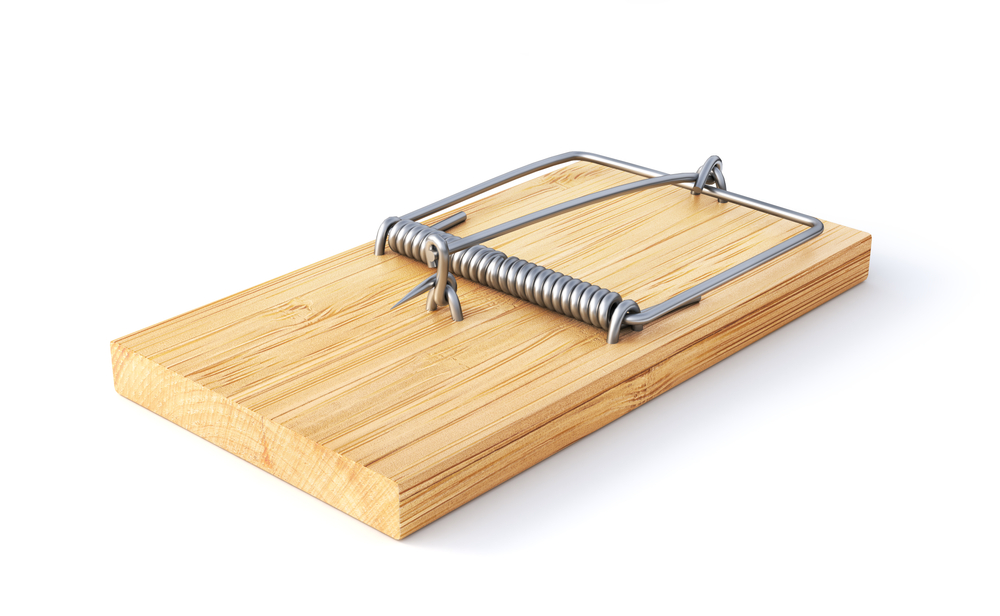A snap trap isolated against a white background