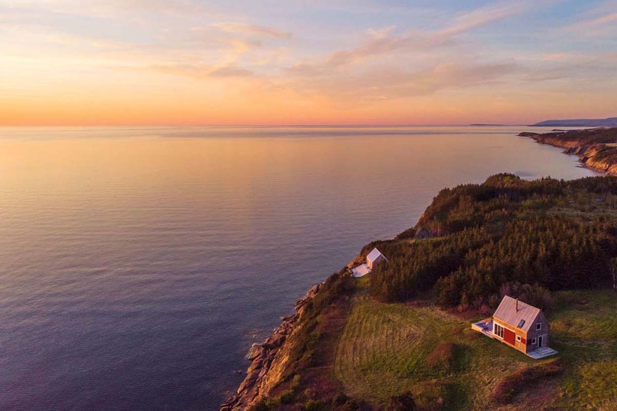An aerial shot of cottages along the coast in Cape Breton