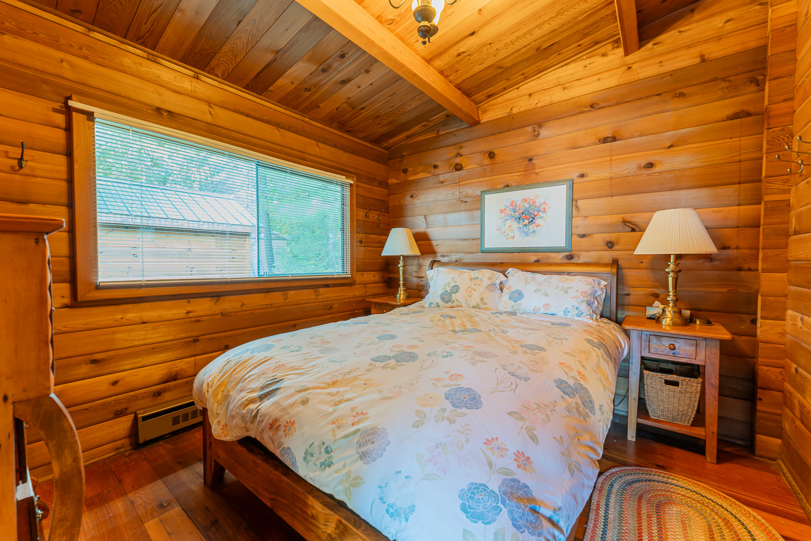 A white floral bed in a wood bedroom