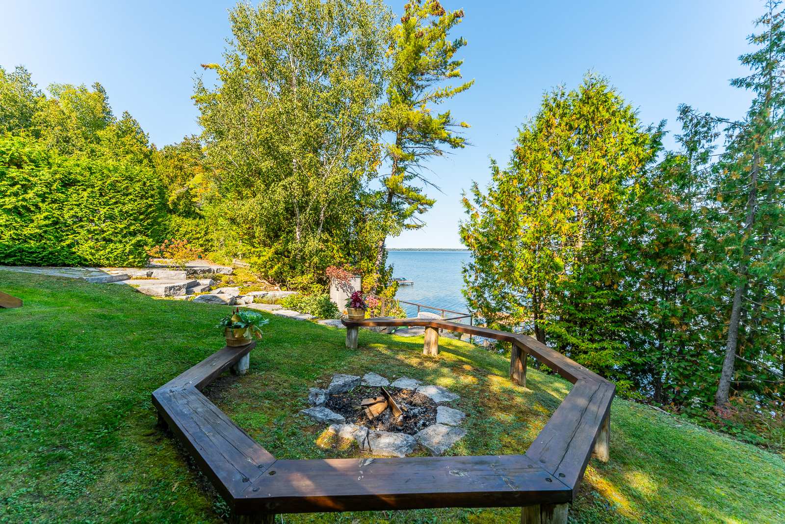 A rounded dark brown bench around a fire pit