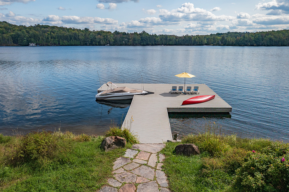 Long composite dock stretching into Lake of Bays, perfect for sunbathing or boating