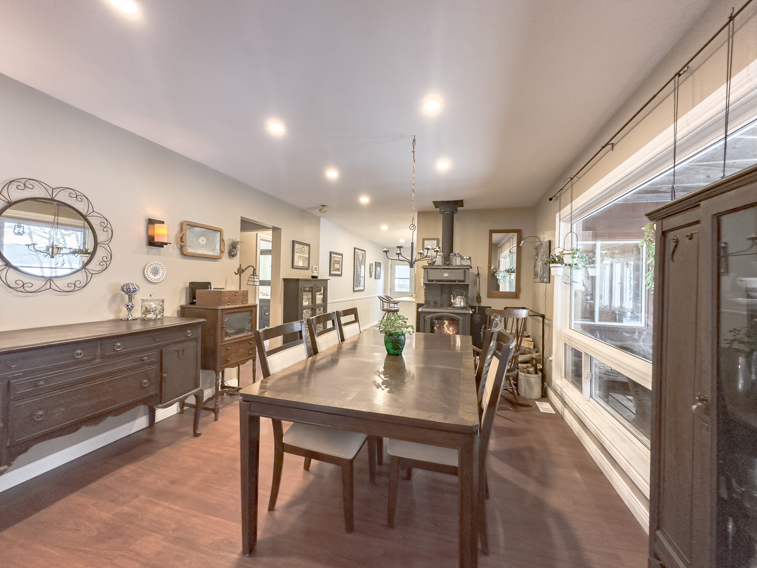 A large dark brown wood dining table with wood chairs in a dining room