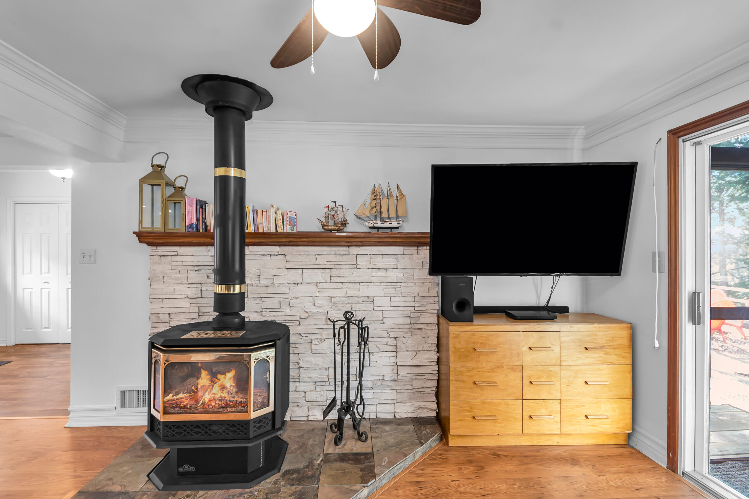 A black wood stove beside a flat-screen TV