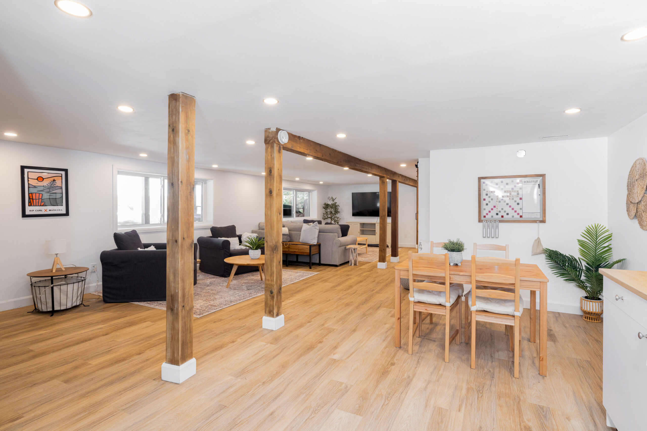A small wood table with wood chairs sits across from the living area