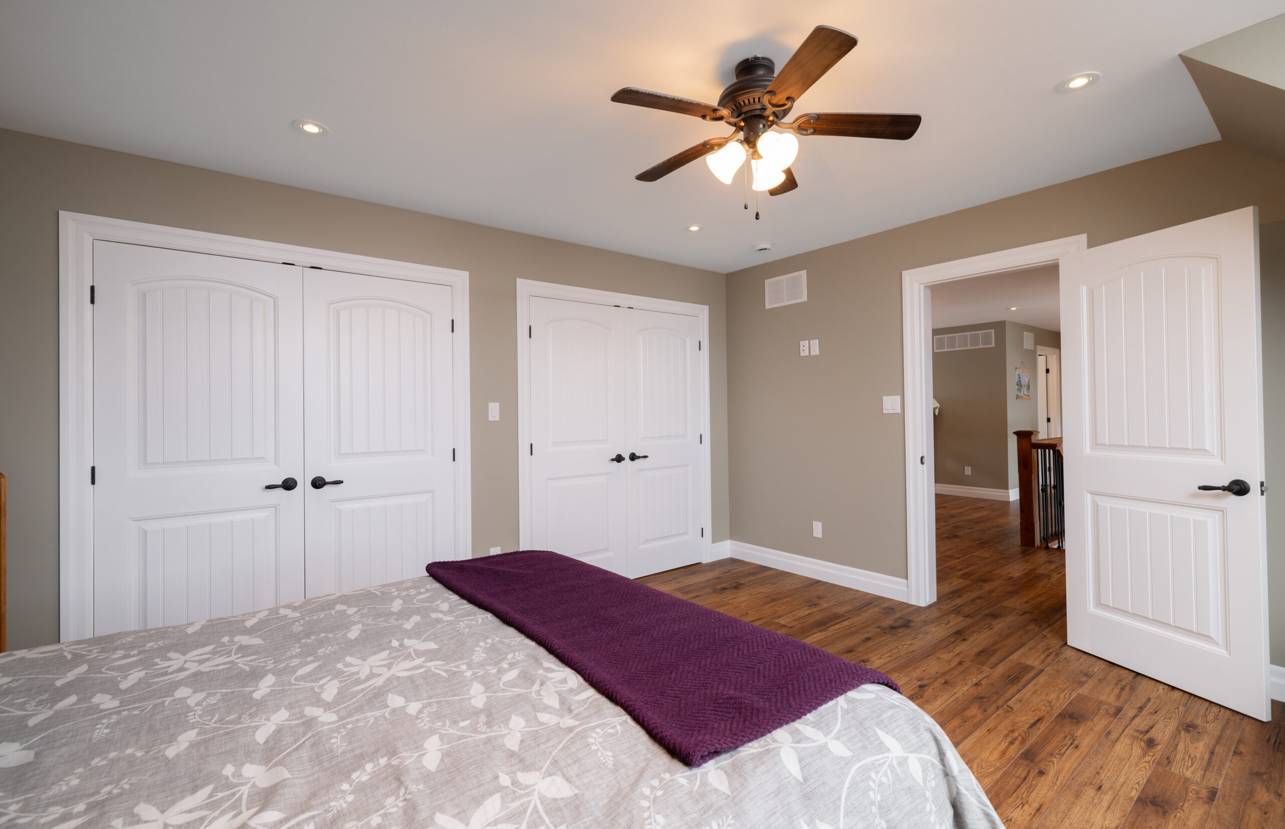 Bedroom with two closets and a bed.