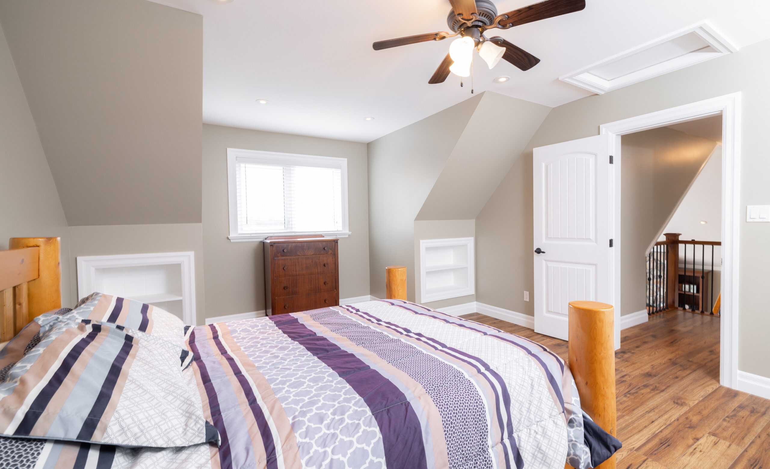 Bedroom with a bed, dresser, and window.