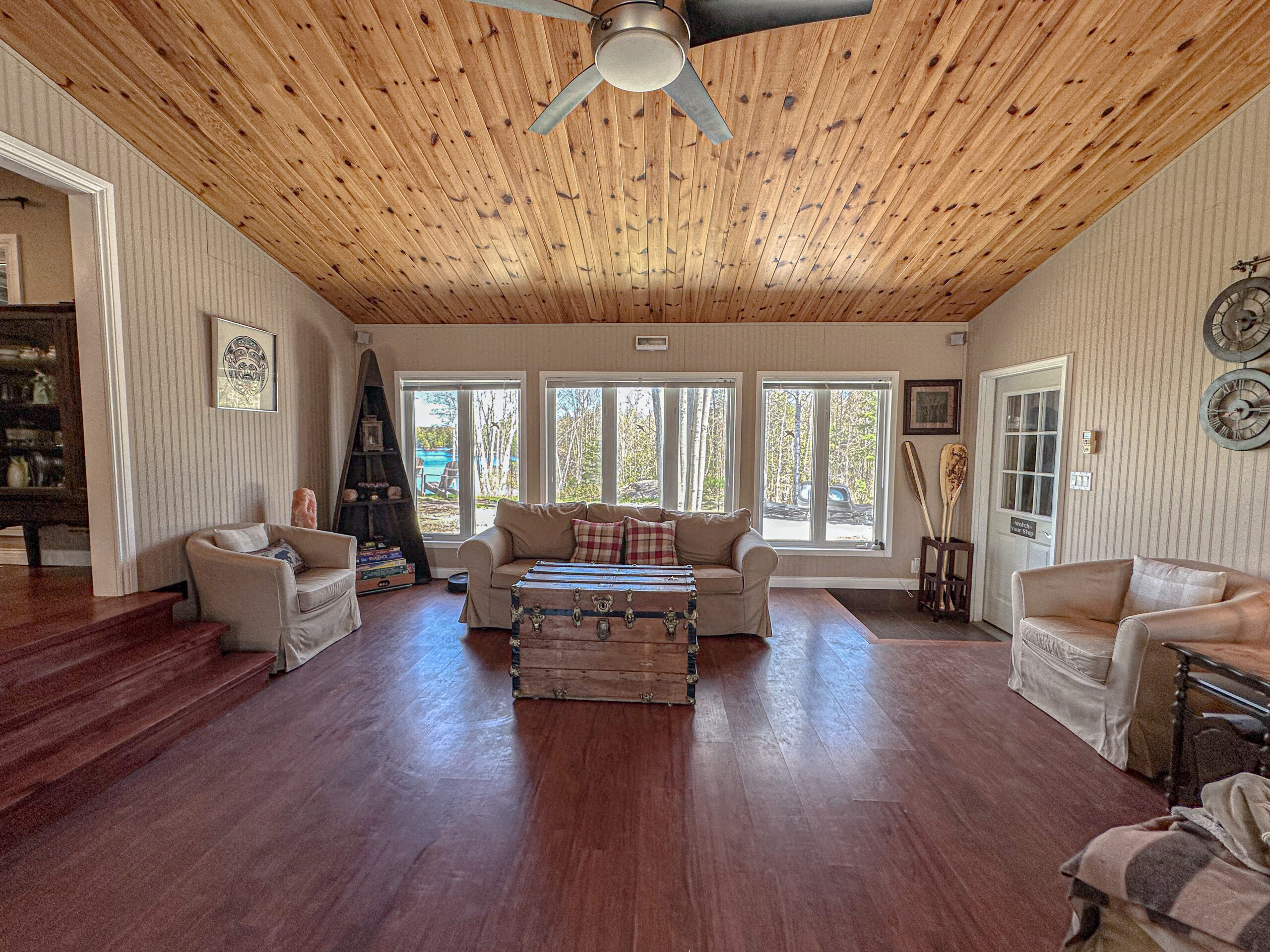 A spacious living room with vaulted wood ceilings