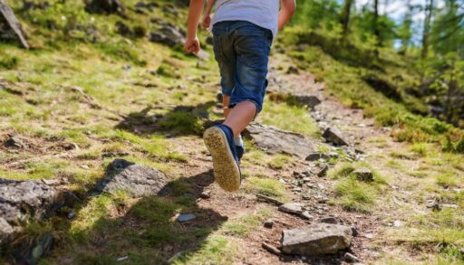 child running on the trail, taking kids to rural areas to help prevent allergies