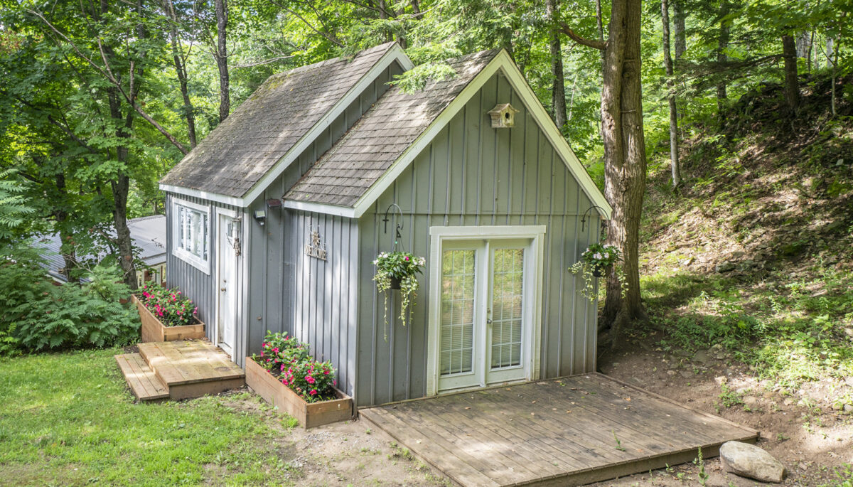 Charming bunkie surrounded by forest, offering a private retreat for guests or kids