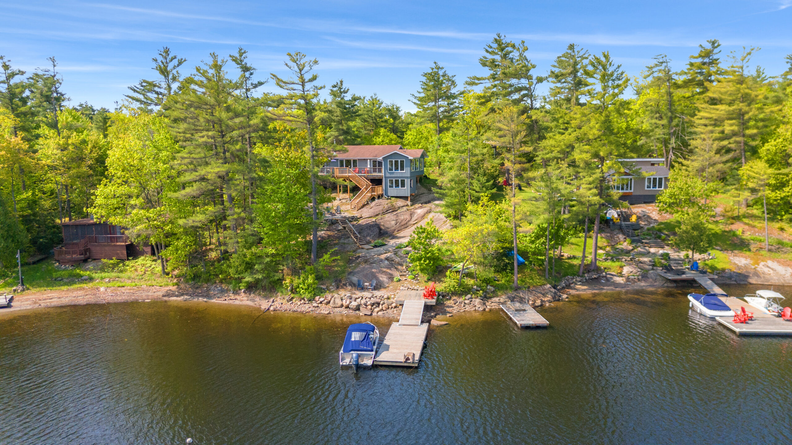 A cottage on a granite rock in the forest overlooking the lake