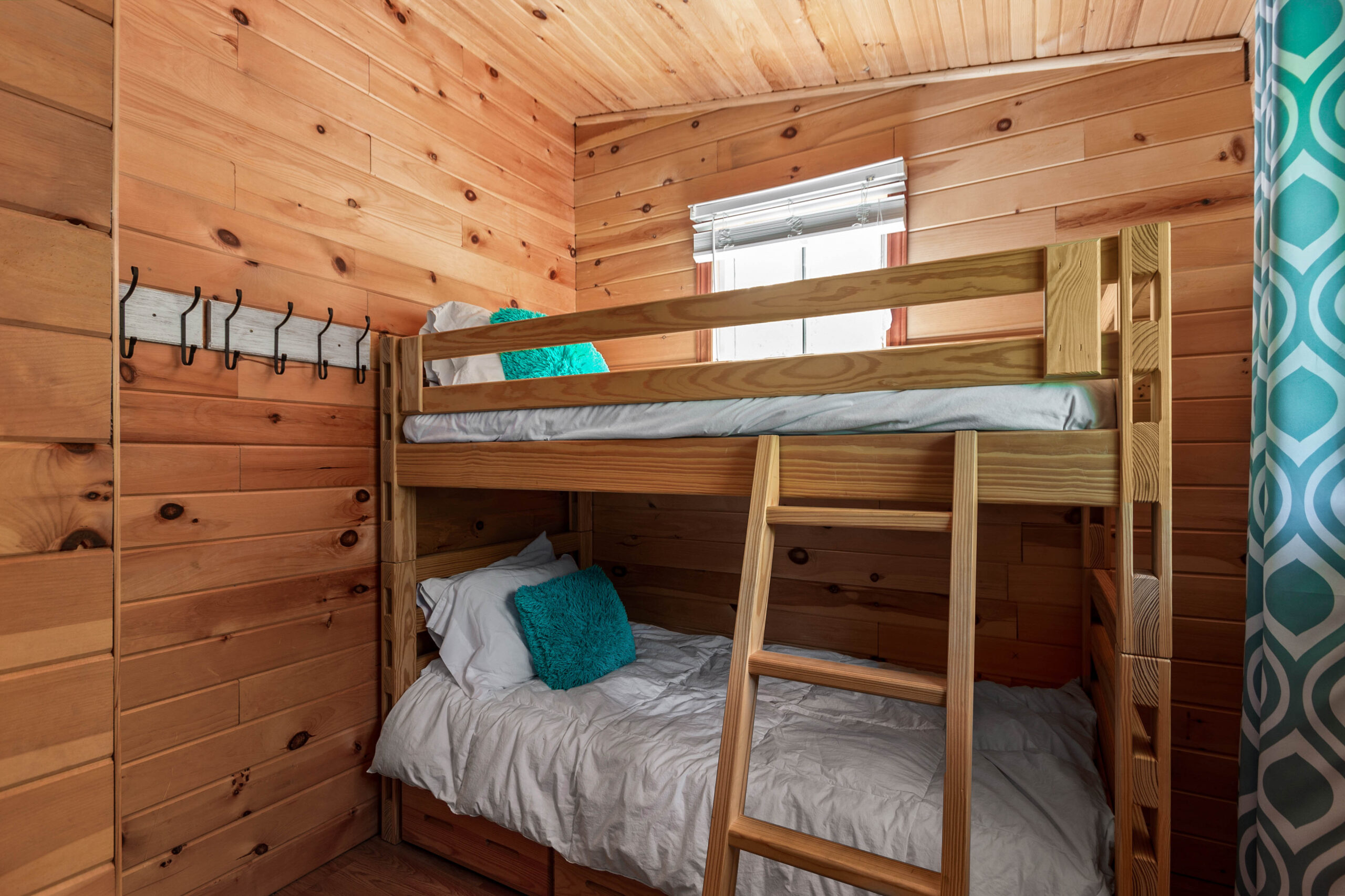 Wood bunk beds in a wood paneled room