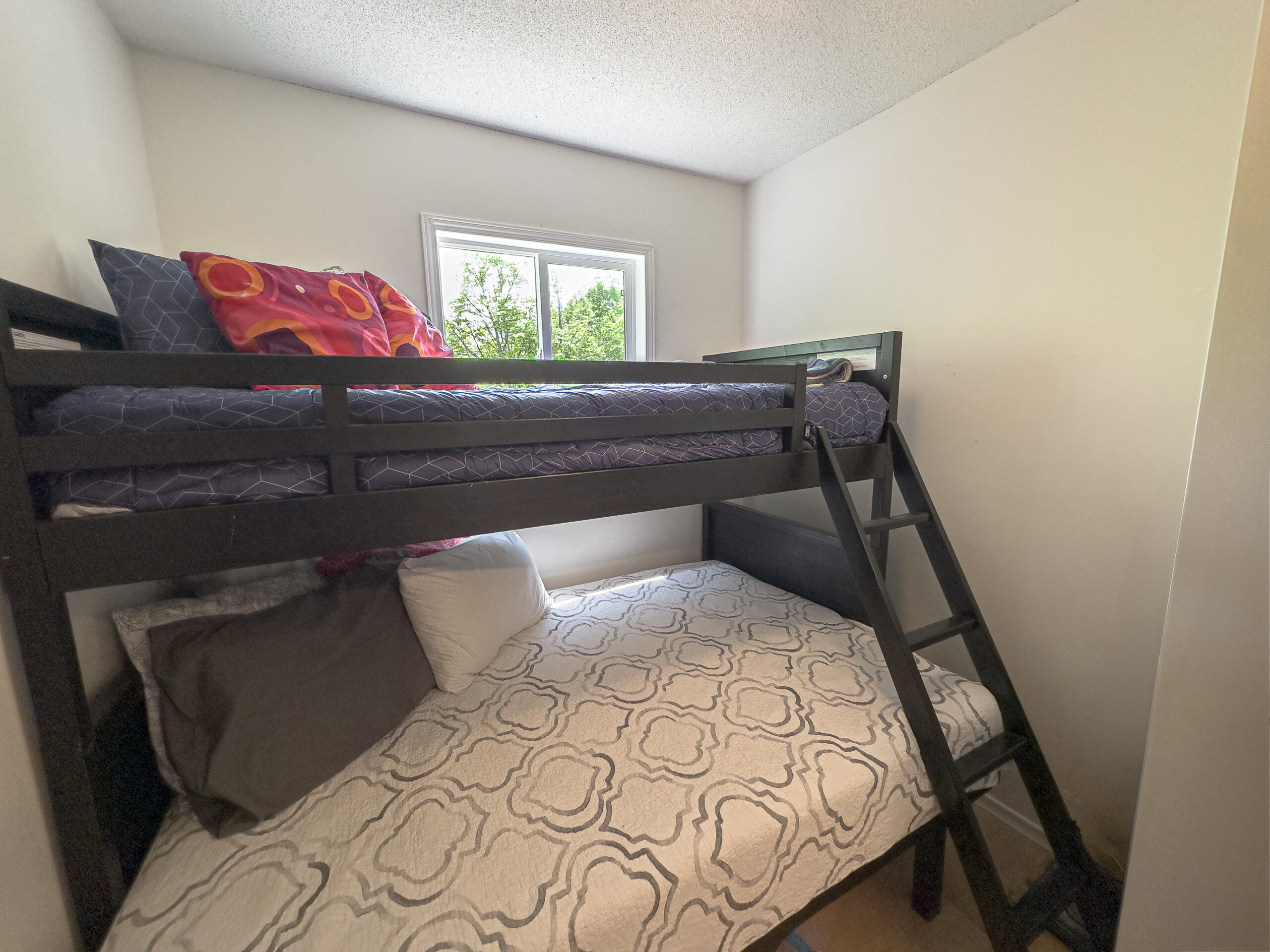 Dark wood bunk beds with white duvets