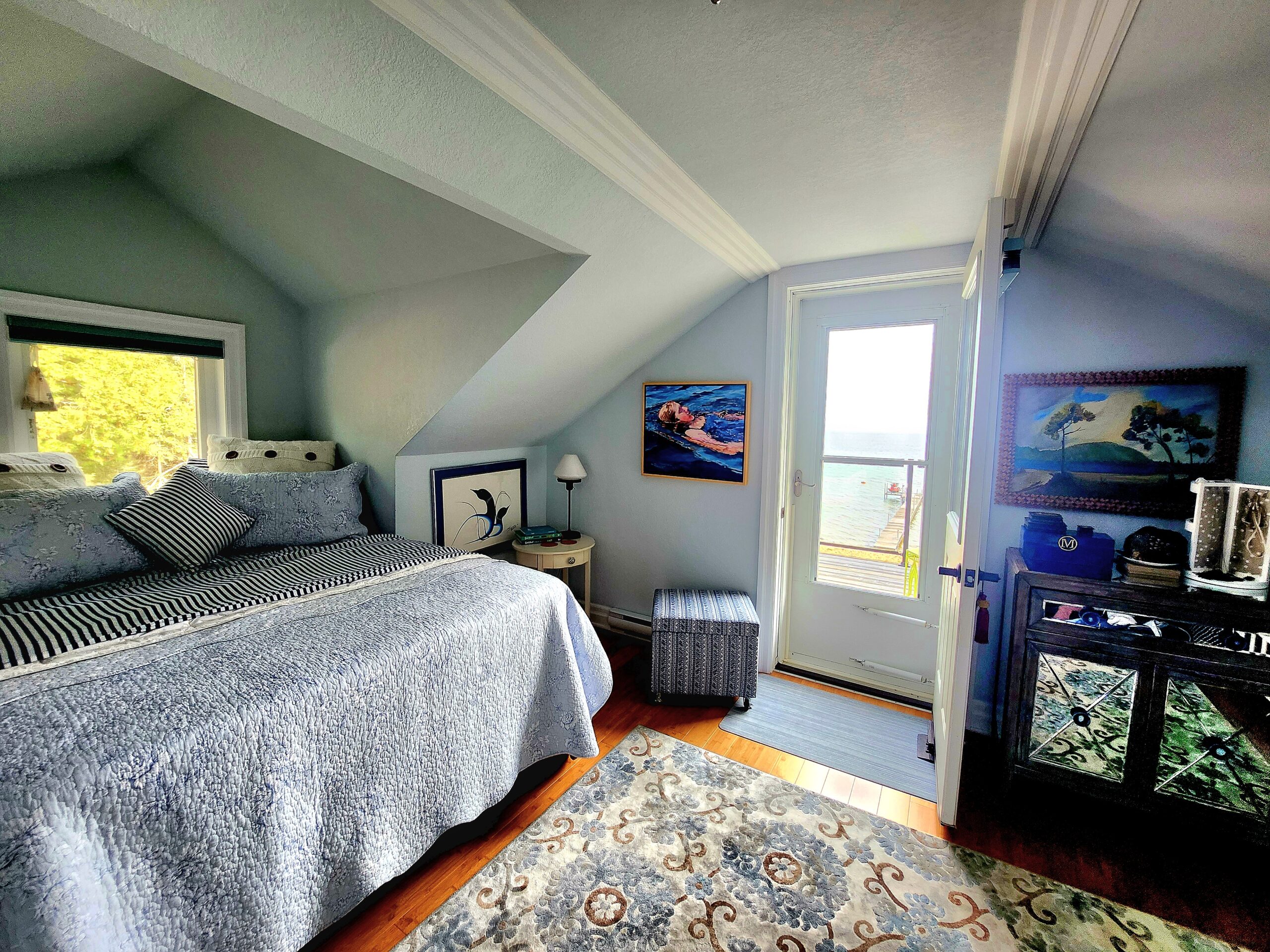Bright attic-style bedroom with sloped ceilings and natural light