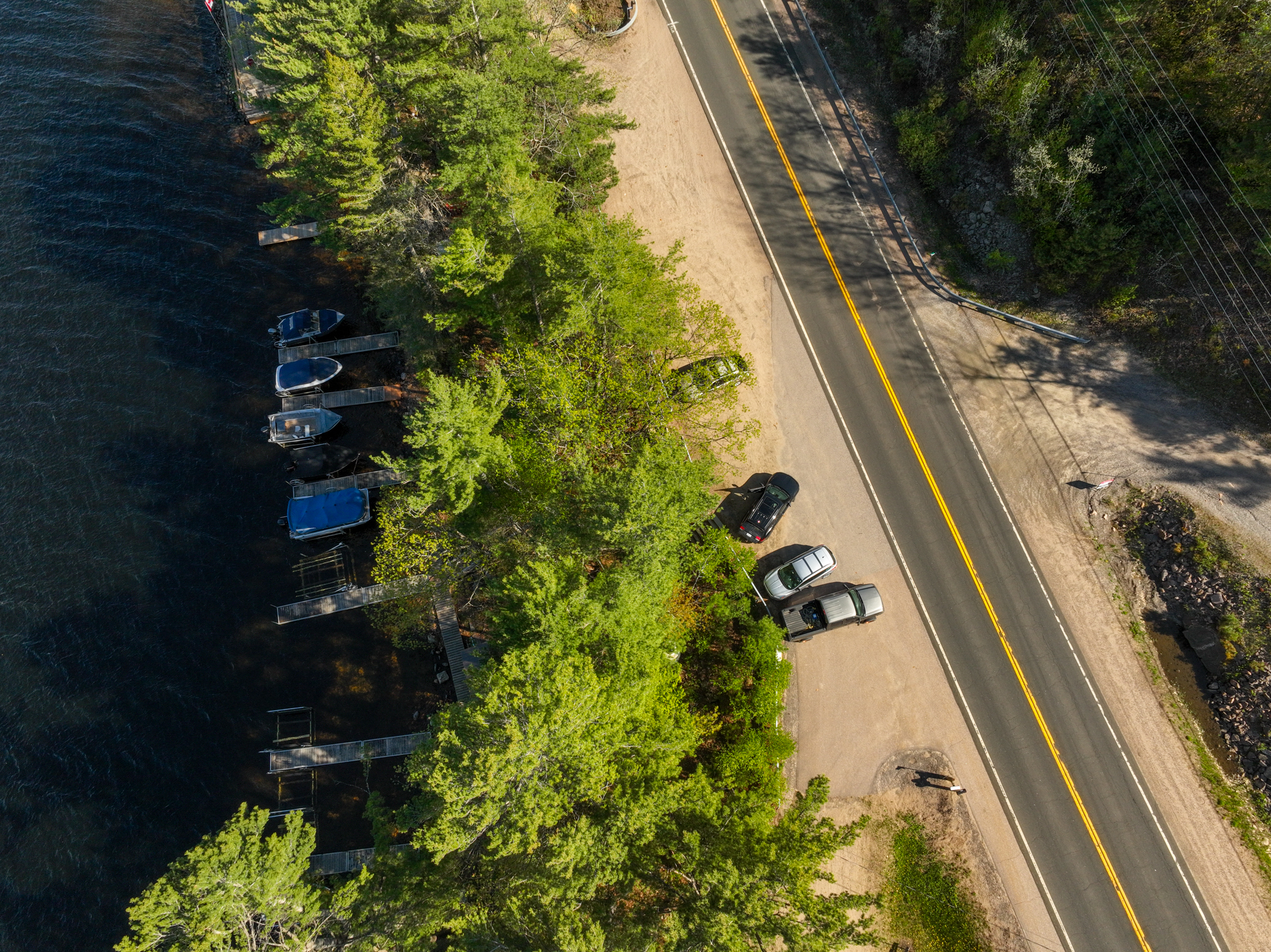 Aerial view of private roadside parking and dock for lake access to the water-only cottage