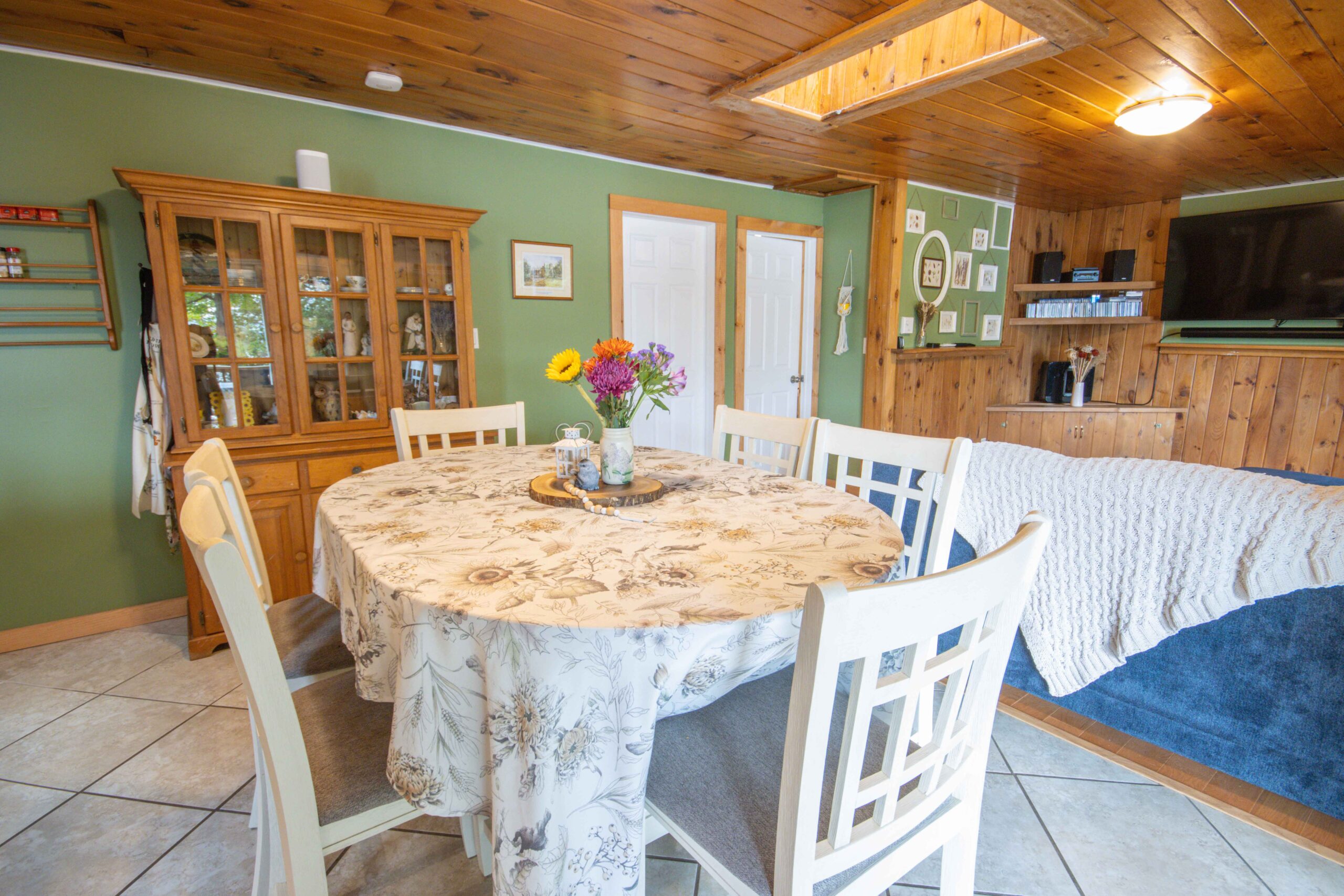 Spacious eat-in kitchen with wooden cabinetry and tiled floors.