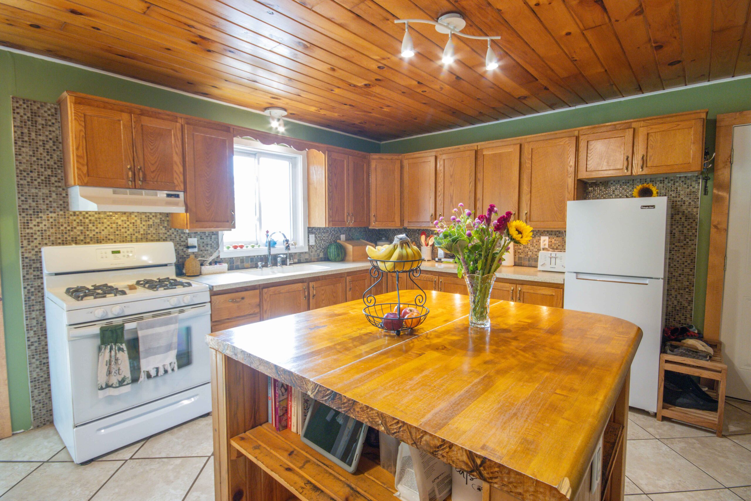 Functional kitchen with large centre island and full appliances.