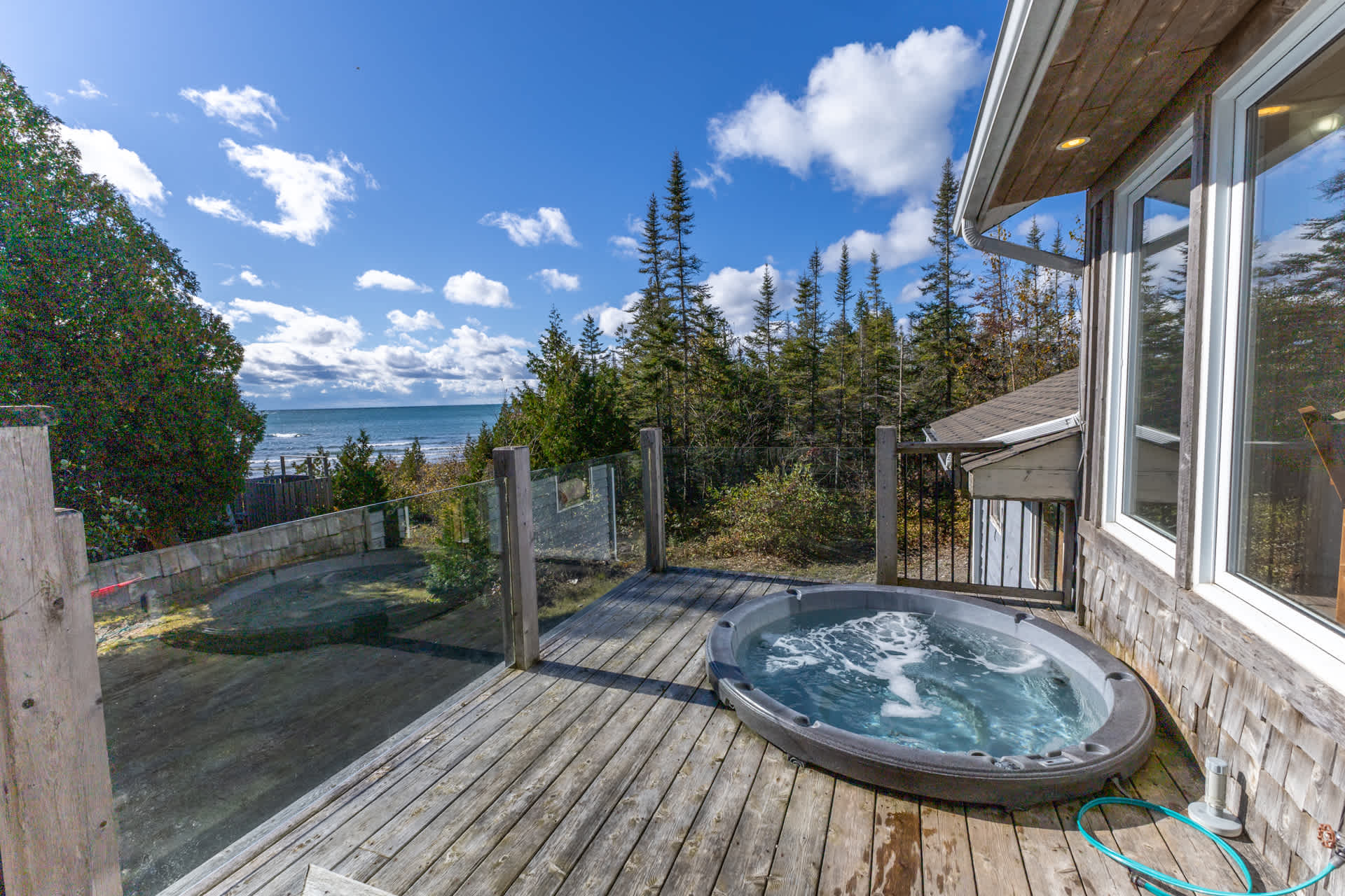 A hot tub sunken into a wood deck