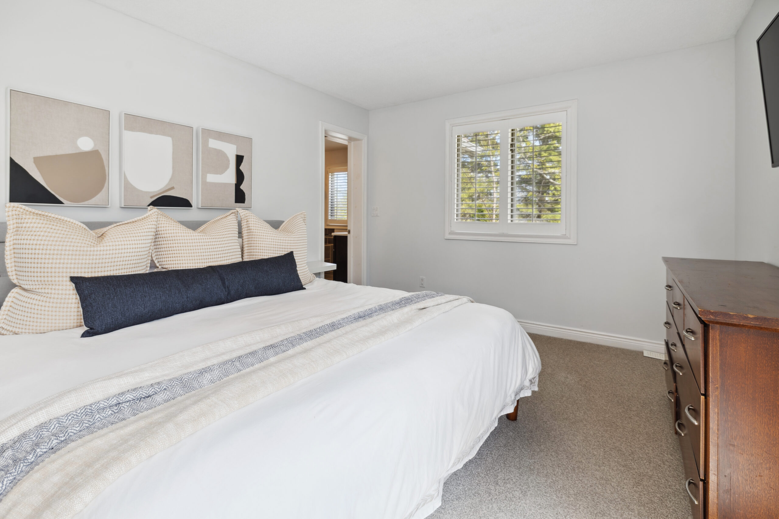 A large white bed in a white bedroom
