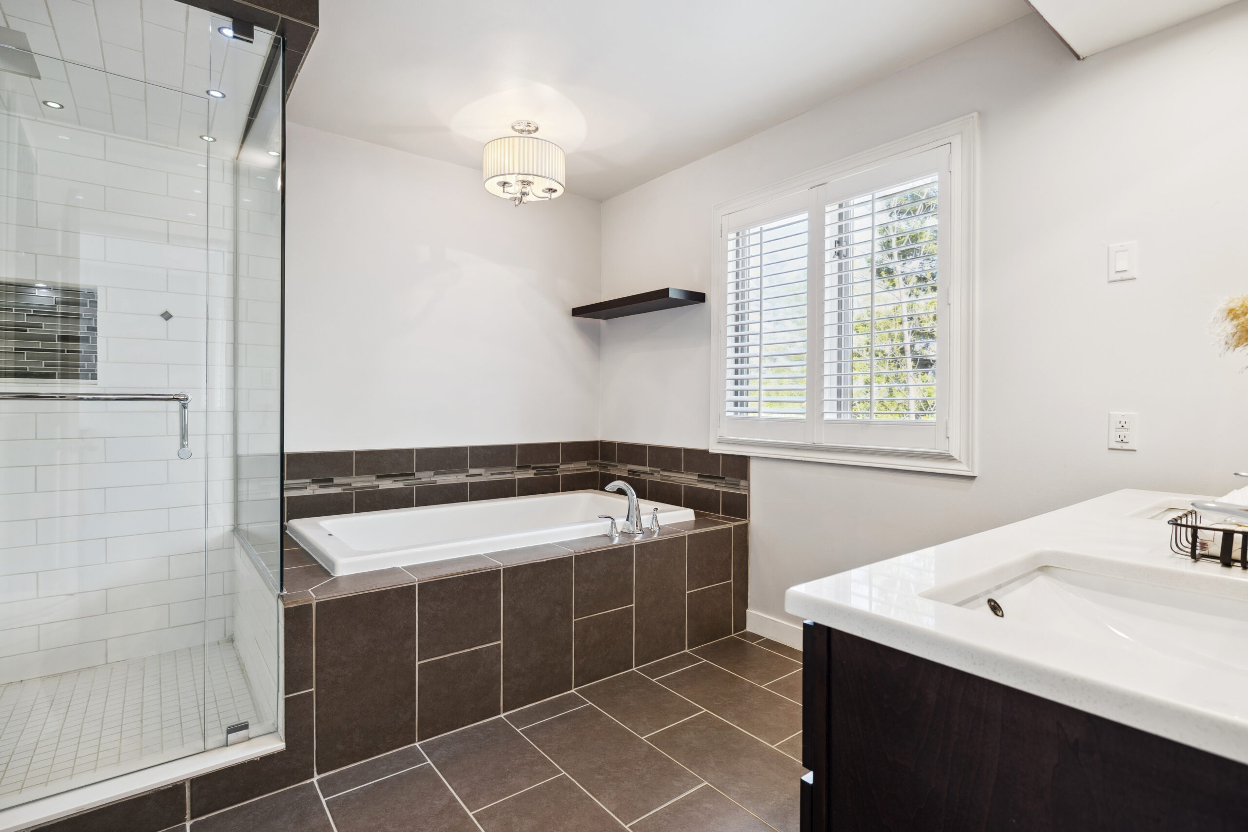 A brown stone bathtub in a white bathroom