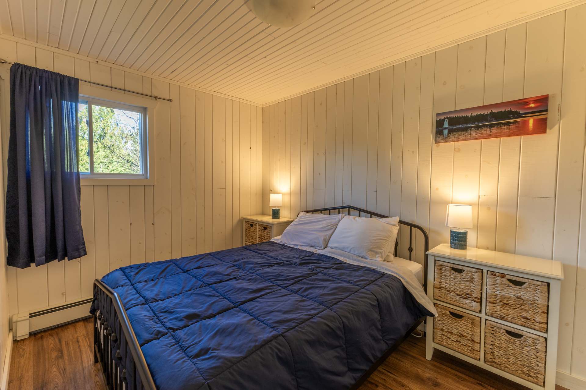 A blue bed in a white bedroom