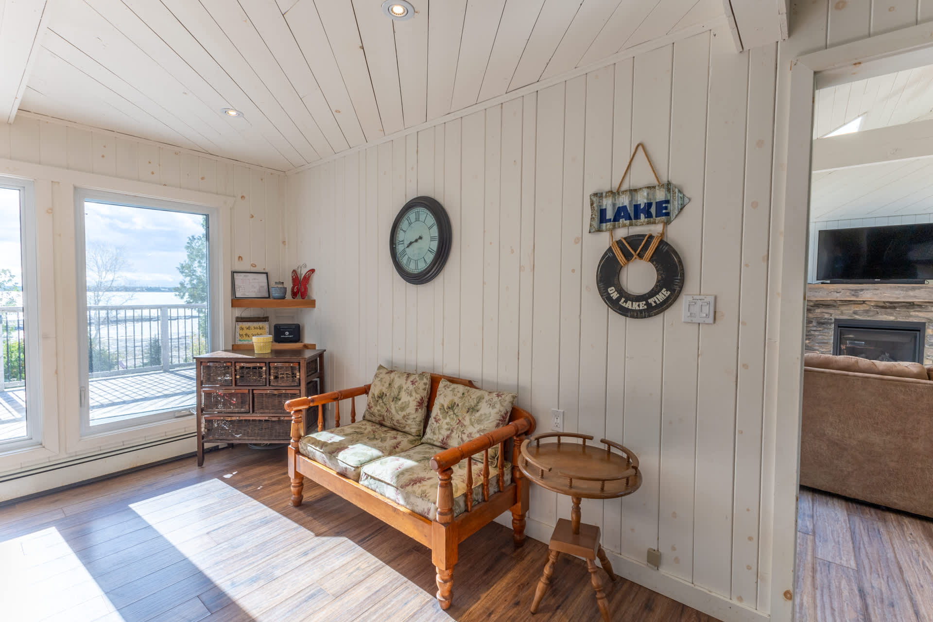 A bench with floral cushions in a white room