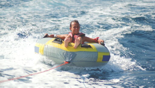 A girl being towed on a tube
