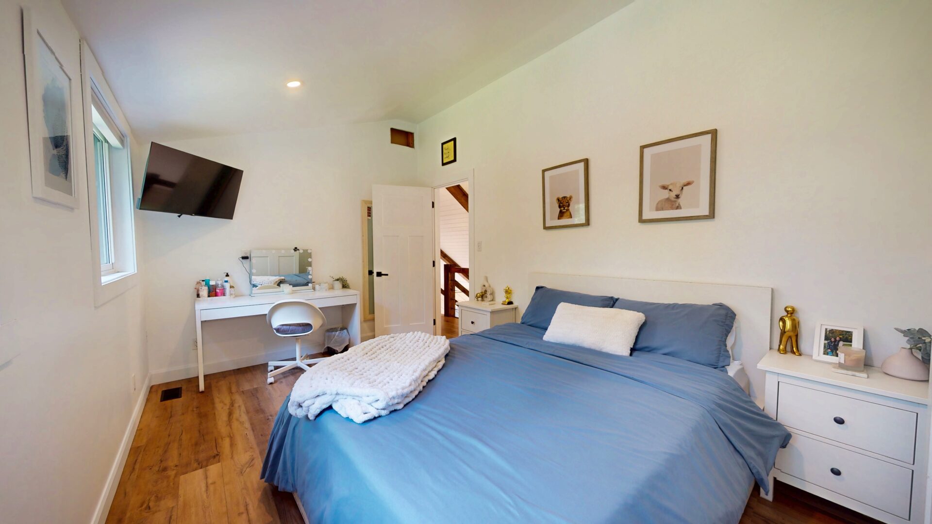 A blue bed in a white bedroom