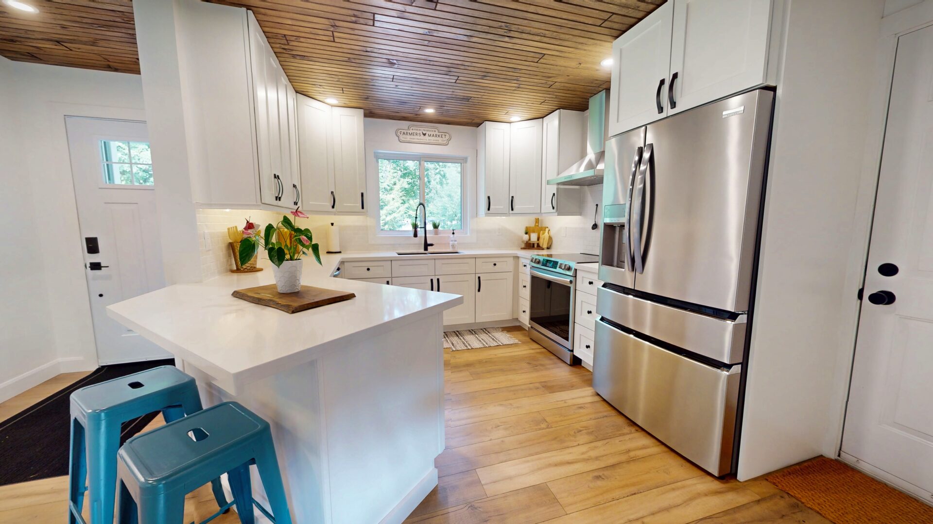 A white kitchen with light wood floors