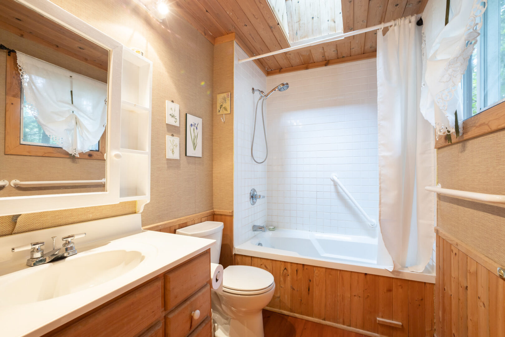 A white bathroom with wood fixtures