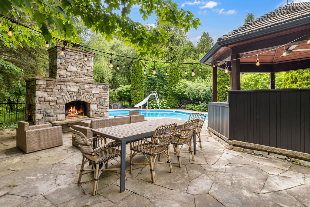 An outdoor dining area next to a stone patio
