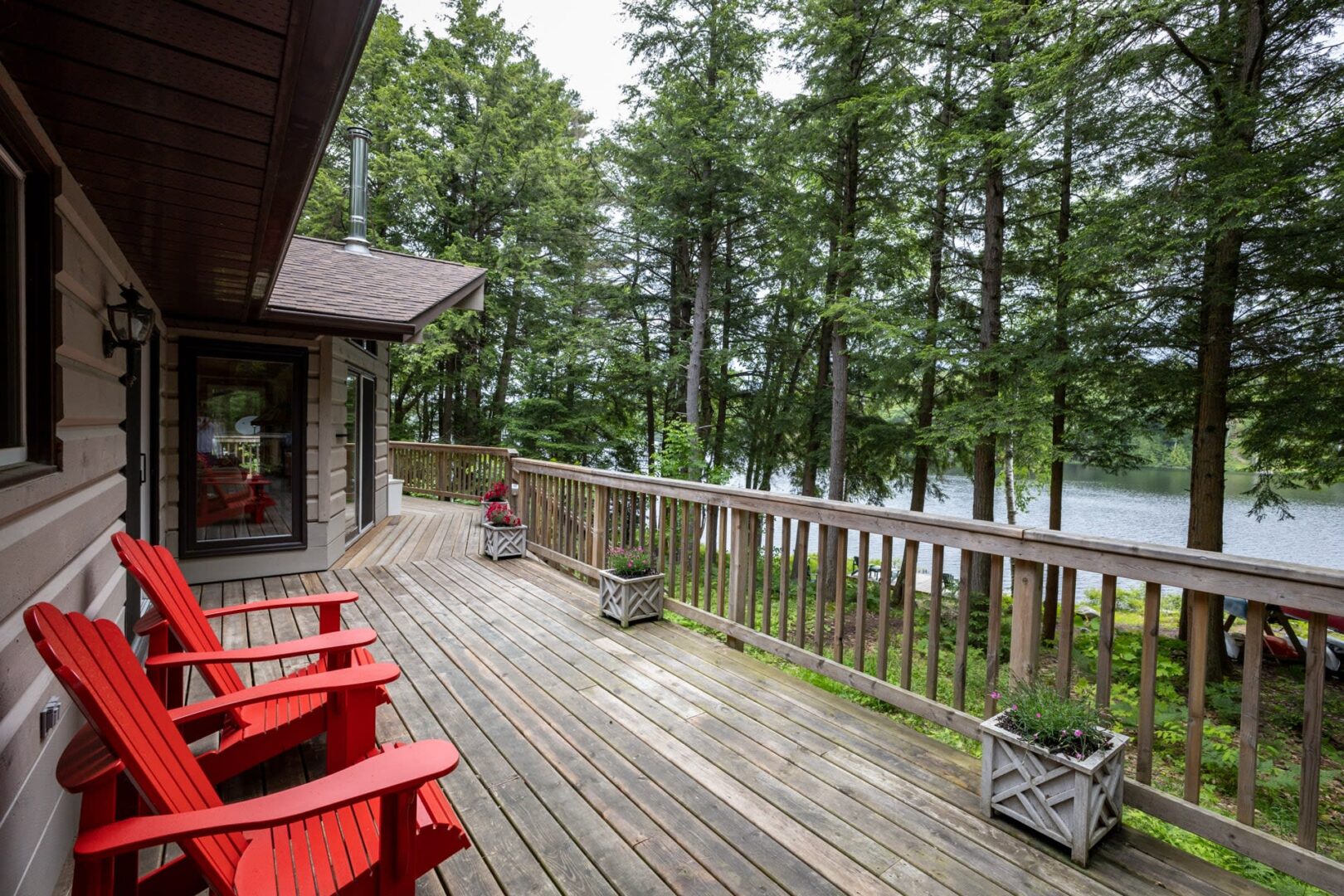 A wood deck along the back of a cottage