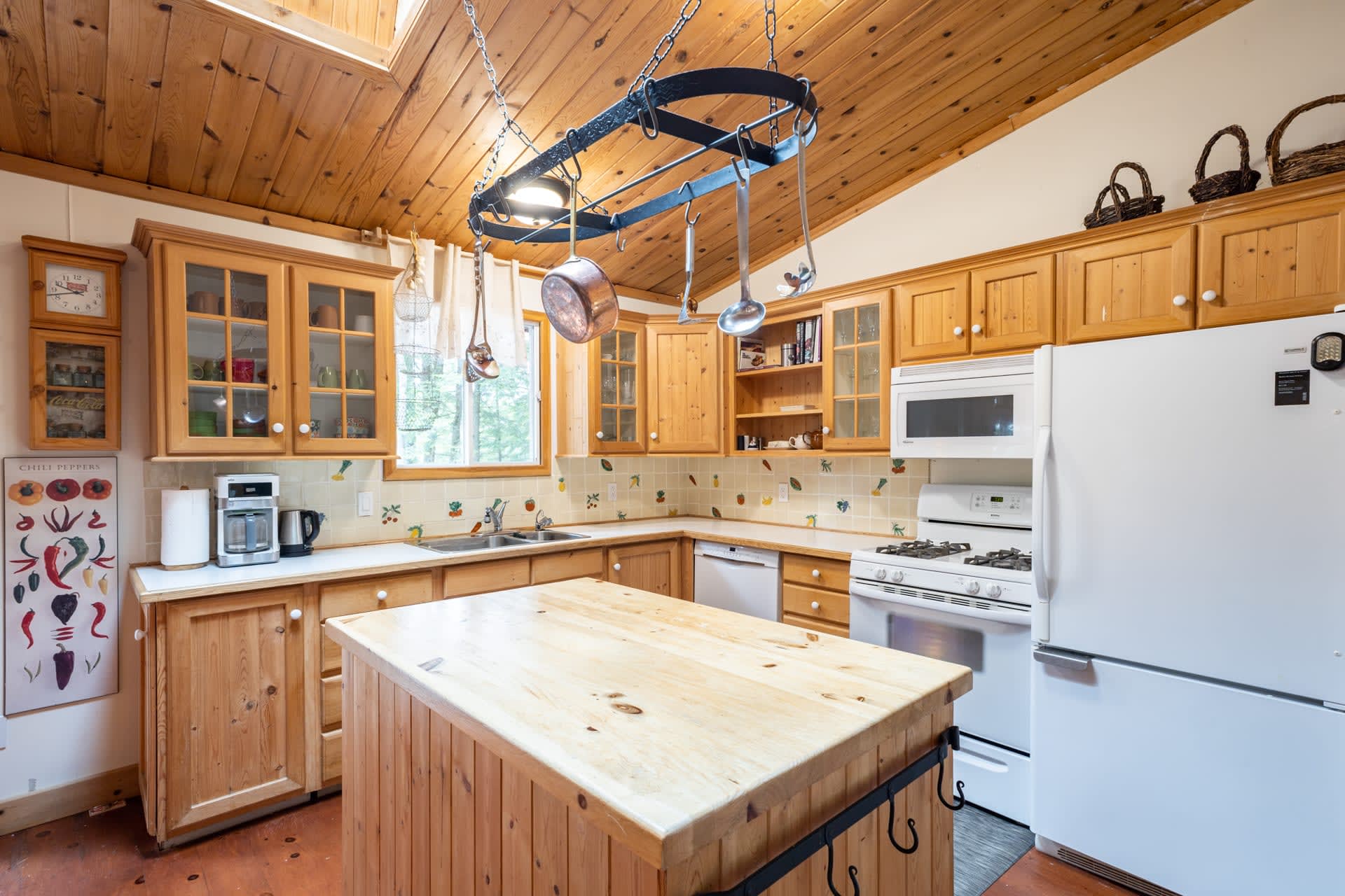 A wood paneled kitchen with a large island