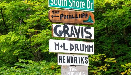 Street sign. Lots. Cottage country. Rural. Northern Ontario. Vacation property home. Cabin. Woods. Arrow. Names. Signpost. Wooden. Wood. Signs. Location. Information. Pride. Ownership. Colorful.